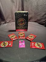 Five sealed packs arranged with display box in background