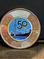 Reverse of colourized 2026 CN Tower 50th anniversary toonie