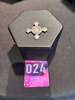 Medallion on display box showing overall size and form