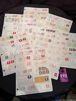 Stack of album pages filled with on-piece Canadian stamps