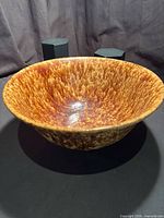 Side view of large mottled brown glazed bowl