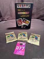 Front view showing three sealed 1990-91 OPC Premier hockey packs and illustrative 1991 OPC box
