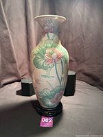 Full view of vase on stand showing shape and decoration