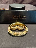 Bracelet and earrings in front of Joan Rivers Classics Collection box