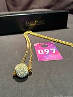 Full necklace with pendant beside Joan Rivers Classics Collection box