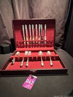 Open chest showing flatware arranged in slots