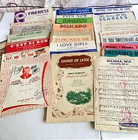 Front view of stacked sheet music showing multiple titles