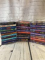 Two vertical stacks and three horizontal Star Trek paperbacks showing spine titles