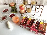 Group shot showing candles, holders, Glade refill boxes, pillar candles, votives, jar candle, taper candle