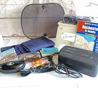 Full lot overview showing UPS, step stool, map booklet, sunshade, umbrella, travel items