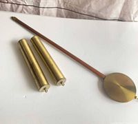 Full view of pendulum and two brass weights