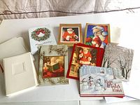 Group of assorted Christmas cards and envelopes on table