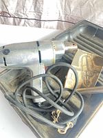 Drill, cord, case interior and manual card