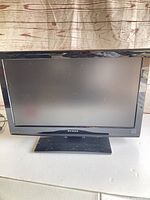 Front view showing full television with stand and screen