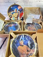 Five boxed plates showing packaging, certificates and condition