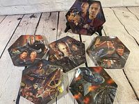 Group shot of six hexagonal plates showing character and ship artwork