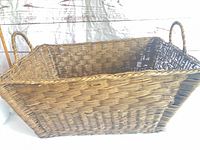 Overall view of large rectangular wicker basket with handles