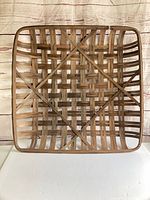 Front view of entire square woven wood tobacco basket