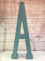 front view of teal distressed metal letter A