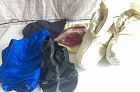 Group shot of all items: swim trunks, sandals, slippers, hat, bandana