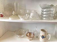 Shelf with multiple pressed glass, crystal pieces and ceramic stein