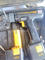 Cordless drill with attached battery packs in case