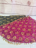 Both shawls folded showing magenta and black versions with floral embellishment