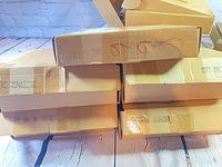 Stack of five yellow cardboard boxes printed with episode titles