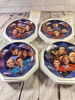 All four Star Trek 30 Years plates in original foam shippers with COAs visible