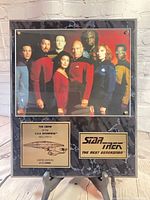 Front view of plaque on easel showing crew image and nameplates