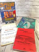 Group shot of all four Star Trek items standing upright