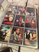 Page of nine Star Trek: TNG Topps cards in binder sleeves