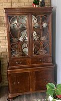 Full view of china cabinet showing upper glass doors, wood overlay, drawers, lower cupboard