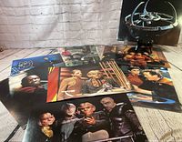 Assorted glossy prints laid out showing various DS9 scenes and characters