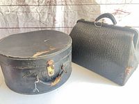 Hat box and Gladstone bag side by side showing overall form and wear