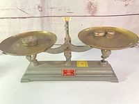 Full view of balance scale with brass pans and weights in place