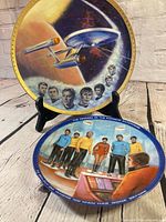 Both Star Trek plates on stand and table