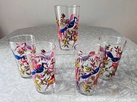 Five Arcoroc tumblers with multicolour bird design on table