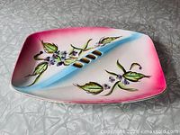 Top view showing full ashtray, floral design, gold rests