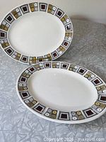 Both oval platters showing full design