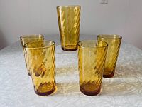 Five amber optic swirl tumblers on table
