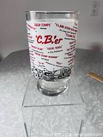 Front view of glass showing C.B.er logo, text, truck graphic