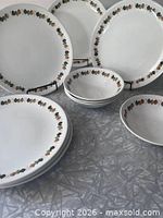 Full set: seven plates and four bowls displayed