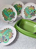 Group shot of all green Melmac pieces and paisley plates