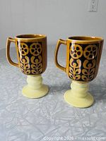 Front view of both matching pedestal mugs
