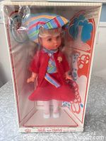 Front view of boxed doll showing outfit and packaging