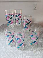 All six tumblers standing on table showing design