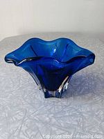 Overall view of blue art glass centrepiece showing wavy rim and clear base
