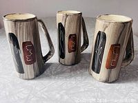 Three Laurentian Art Ware mugs showing full design and handles
