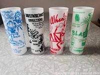 Front view of all four tumblers showing graphics and colours